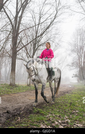 young woman riding in the fog Stock Photo