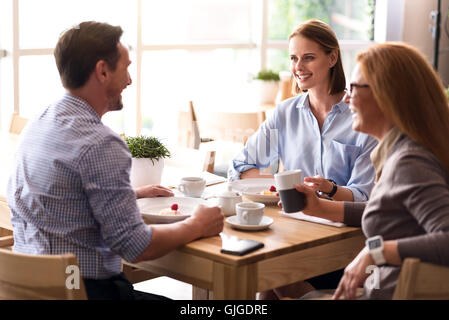 Joyful colleagues having lunch Stock Photo