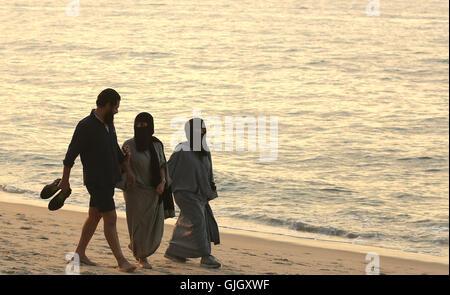 Penang, MALAYSIA. 24th Feb, 2016. Muslim women, wearing full burqas, and men enjoy a day at the beach in Penang, Malaysia on February 21, 2016. The mayor of Cannes in southern France has banned full-body swimsuits known as ''burkinis'' from the beach, citing public security concerns and fears. © Stephen Shaver/ZUMA Wire/Alamy Live News Stock Photo