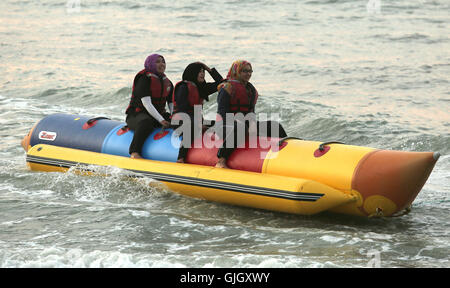 Penang, MALAYSIA. 24th Feb, 2016. Muslim women enjoy a day at the beach in Penang, Malaysia on February 21, 2016. The mayor of Cannes in southern France has banned full-body swimsuits known as ''burkinis'' from the beach, citing public security concerns and fears. © Stephen Shaver/ZUMA Wire/Alamy Live News Stock Photo