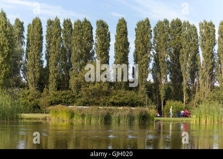 Milton Keynes, UK. 16th August, 2016. A bright summer's day over Campbell Park showing the boat moorings on the Grand Union canal and people aside the beautiful lake enjoying a sunny calm day. Credit:  Robert Norris/ Alamy Live News