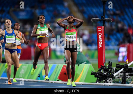 Rio De Janeiro, Brazil. 16th Aug, 2016. Kenya's Faith Chepngetich Kipyegon (R) celebrates after crossing the finish line during the women's 1500m final of Athletics at the 2016 Rio Olympic Games in Rio de Janeiro, Brazil, on Aug. 16, 2016. Faith Chepngetich Kipyegon won the gold medal. Credit:  Liu Dawei/Xinhua/Alamy Live News Stock Photo