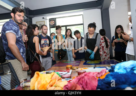 Nantong, Nantong, China. 17th Aug, 2016. Nantong, CHINA-August 2 2016-(EDITORIAL USE ONLY. CHINA OUT) College students from Israel are interested in making engraved painting at the 1895 Cultural Creativity Park. More than 30 college students from China and abroad visit Nantong Blue Calico Museum, China Abacuses Museum, Association of Opera Artists, studio of intangible cultural heritage and other places, appreciating the beauty of Chinese intangible cultural heritage including Peking Opera and Chinese abacus. The visiting team, consisting of students from Tel Aviv University, University of Stock Photo