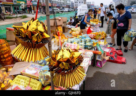 Anyang, Anyang, China. 17th Aug, 2016. Anyang, CHINA-?August 16?2016:?(EDITORIAL?USE?ONLY.?CHINA?OUT) Various weird offerings including fake iPhones, villas, false paper money and cigarettes are on sale in Hua County, central ChinaÂ¡Â¯s Henan Province, before the traditional Zhongyuan Festival comes. Chinese traditional Zhongyuan Festival, also known as Ghost Festival, is celebrated on 15th day of the seventh lunar month. People usually burn incense and paper money as an offering to the spirits of deceased ancestors during the festival. © SIPA Asia/ZUMA Wire/Alamy Live News Stock Photo