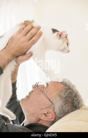 Man playing with cat Stock Photo