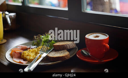 Smoked salmon, scrambled egg an toast with cappuccino coffee Stock Photo