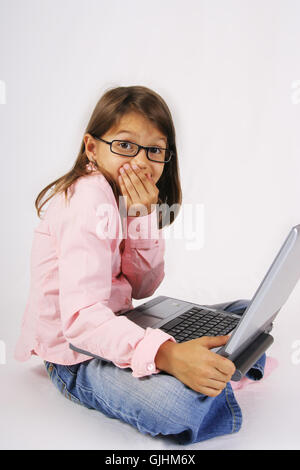 School girl hold laptop notebook on isolated studio background ...