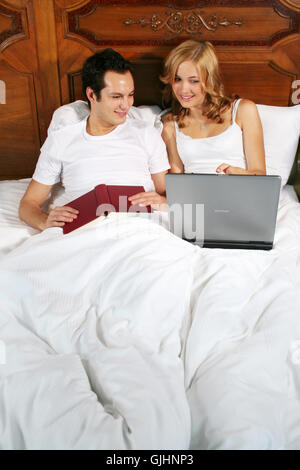 work and reading in bed Stock Photo