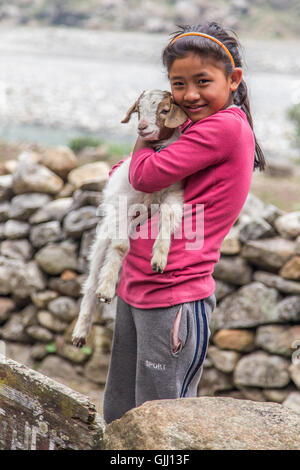 Nepal, girl with goat in mountain village. Stock Photo