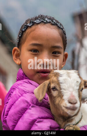 Nepal, girl with goat in mountain village. Stock Photo