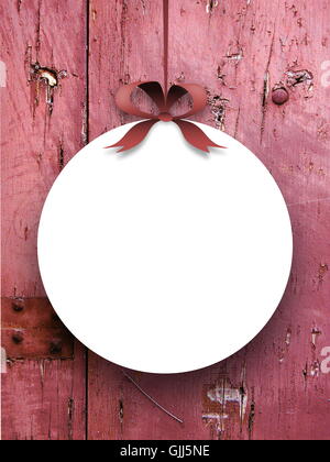 Close-up of one blank round frame hanged by ribbon against red weathered wooden boards background Stock Photo