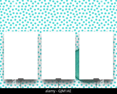 Close-up of three blank frames supported by clips against aqua dotted illustration background Stock Photo