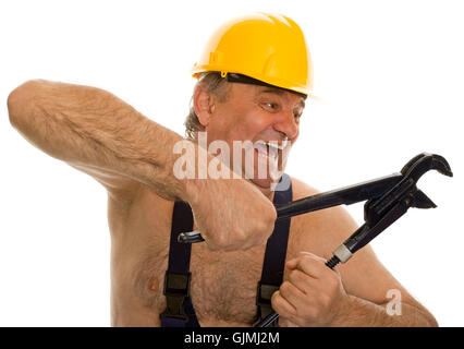 plumber with pipe wrench and safety helmet Stock Photo