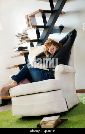 woman armchair laugh Stock Photo