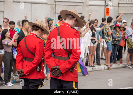 Montreal, CA - 16/08/14: Two Royal Canadian Mounted Police officers observe a minute of silence in memory of Orlando victims Stock Photo