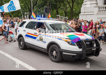 Montreal, CA - 14 August 2016: A car of the Royal Canadian Mounted Police with gay canadian rainbow flags Stock Photo