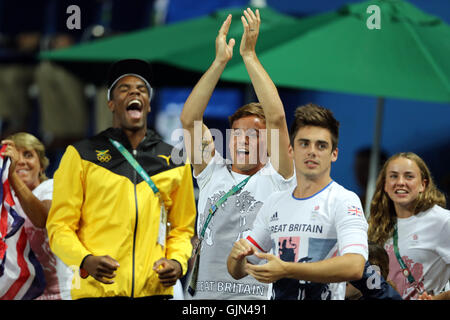 Great Britain's Tom Daley (centre) celebrates as Jack Laugher wins a silver medal in the men's three metres springboard at the Maria Lenk Aquatics Centre on the eleventh day of the Rio Olympics Games, Brazil. Stock Photo