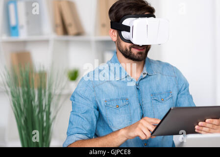 Delighted man using tablet Stock Photo