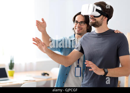 Positive colleagues testing virtual reality glasses Stock Photo