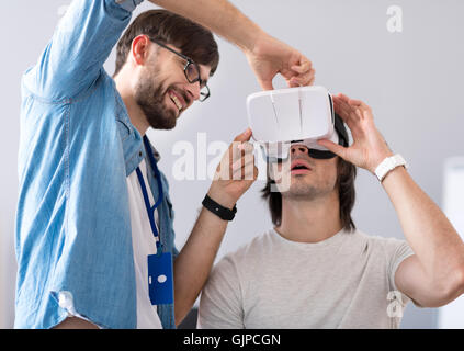 Positive colleagues testing virtual reality device Stock Photo