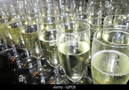 Champagne glasses party celebrate Clinking glasses of champagne in hands on bright lights background stock photo, stock, photograph, image, picture Stock Photo