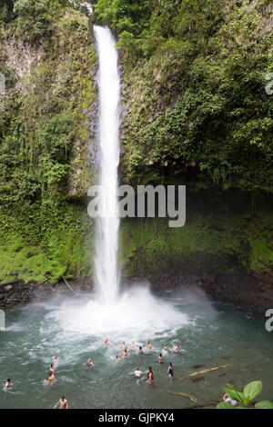 People swimming in the pool below La Fortuna Waterfall, La Fortuna, Costa Rica, Central America (see also image GJPKY7 )