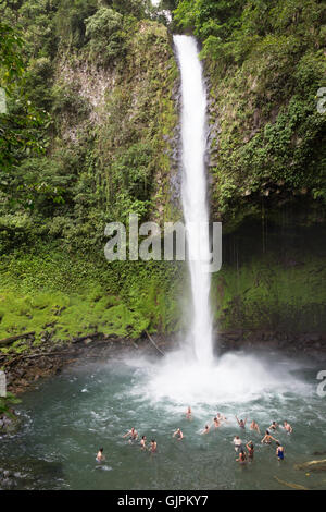 People swimming in the pool below La Fortuna Waterfall, La Fortuna, Costa Rica, Central America (See also image GJPKY4 )