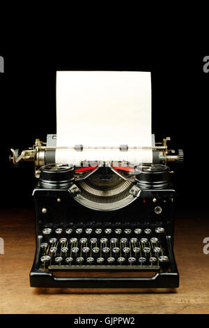 Old vintage typewriter with blank paper Stock Photo