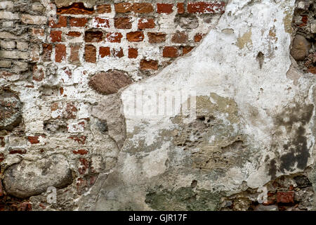 White red old brick painted wall with damaged plaster texture background Stock Photo