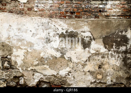 White red old brick painted wall with damaged plaster texture background Stock Photo