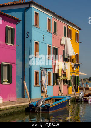 The traditional colourful painted buildings with laundry hanging outside on washing-lines, on the island of Burano. Italy Stock Photo