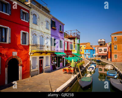 The traditional colourful painted canal side terrace houses on the island of Burano. Venice, Italy. Stock Photo
