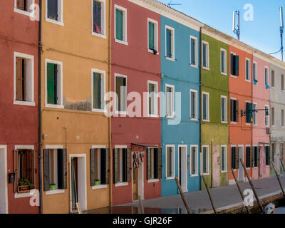 The traditional colourful painted canalside terrace houses on the island of Burano. Venice, Italy. Stock Photo