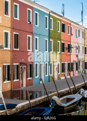 The traditional colourful painted canalside terrace houses on the island of Burano. Venice, Italy. Stock Photo