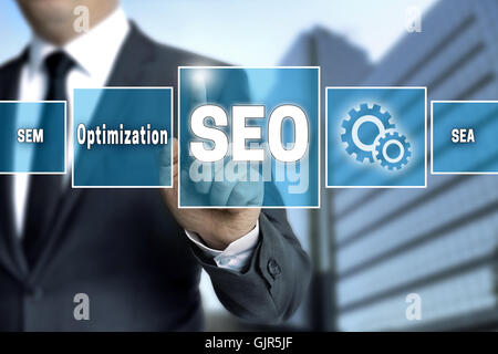 seo touchscreen is operated by businessman Stock Photo