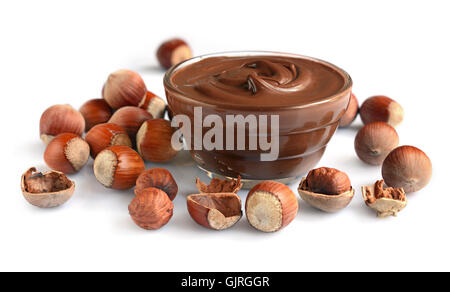 Homemade hazelnut spread in glass bowl with nuts isolated on a white Stock Photo