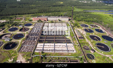 An industrial wastewater treatment plant located in evergreen forest and lakes Stock Photo