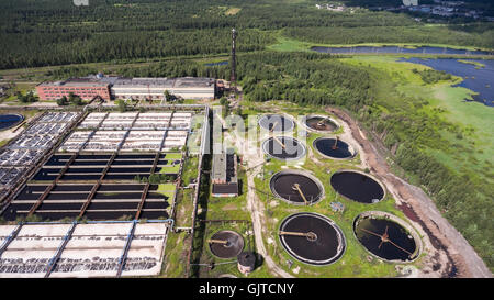 Territory of water treatment plant located in coniferous woods. Aerial view from drone Stock Photo