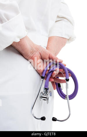 Close up view of doctors hands holding stethoscope behind back, isolated on white background Stock Photo