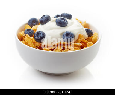 Bowl of corn flakes and blueberries with yogurt isolated on white background Stock Photo
