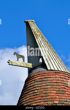 Oast house (hop kiln) in Kent. Cowl at the top, turning with the wind to allow ventilation for the hops drying below. Stock Photo