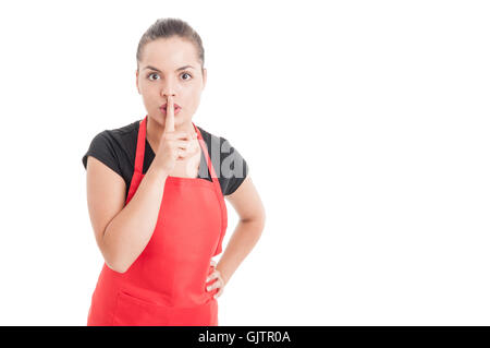 Young hypermarket seller doing a shush gesture as silence or quiet concept isolated on white with copy space Stock Photo
