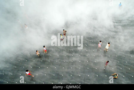 Quanzhou, China's Fujian Province. 16th Aug, 2016. People enjoy coolness among vapour on a square at the Maritime Silk Road Art Park in Quanzhou City, southeast China's Fujian Province, Aug. 16, 2016. Credit:  Zhang Jiuqiang/Xinhua/Alamy Live News Stock Photo