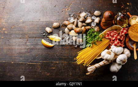 Dark wooden background with Ingredients for cooking Spaghetti vongole Stock Photo