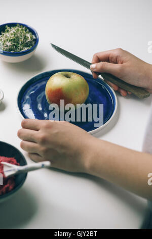 Picture of apple on a blue handmade plate Stock Photo