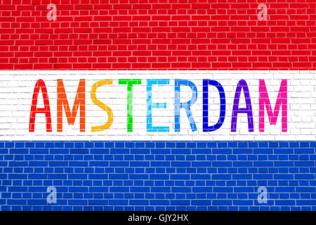 Flag of the Netherlands on brick wall texture background. Multicolored word Amsterdam. Stock Photo