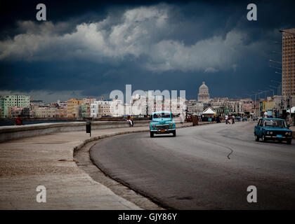 A blue car on a road in Havana, Cuba, in a cloudy day Stock Photo