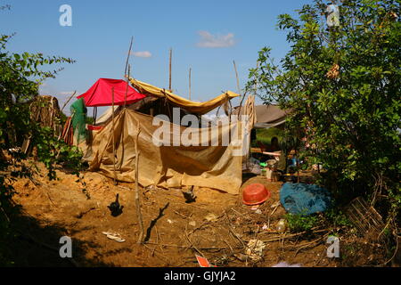 a shack made of plastic, cardboard, and stick where lives a poor Cambodian family Stock Photo