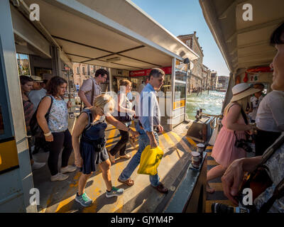 Passengers boarding the water bus or vaporetto, on the Grand Canal in Venice, Italy. Stock Photo