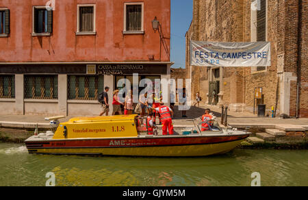 Female patient being helped by paramedics to board a water ambulance. Venice,  Murano, Italy. Stock Photo